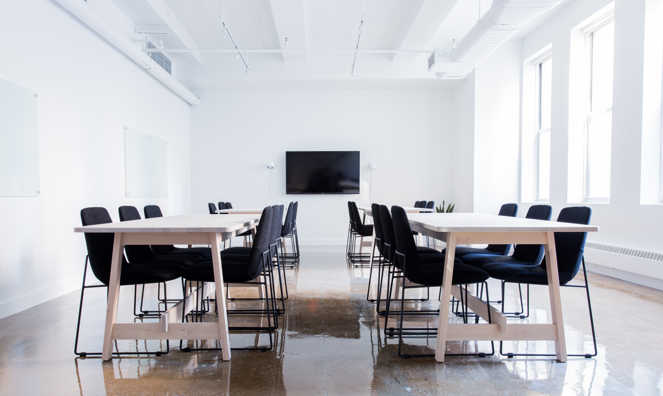 Empty corporate office with glowing AI interface symbolizing automation and job displacement.